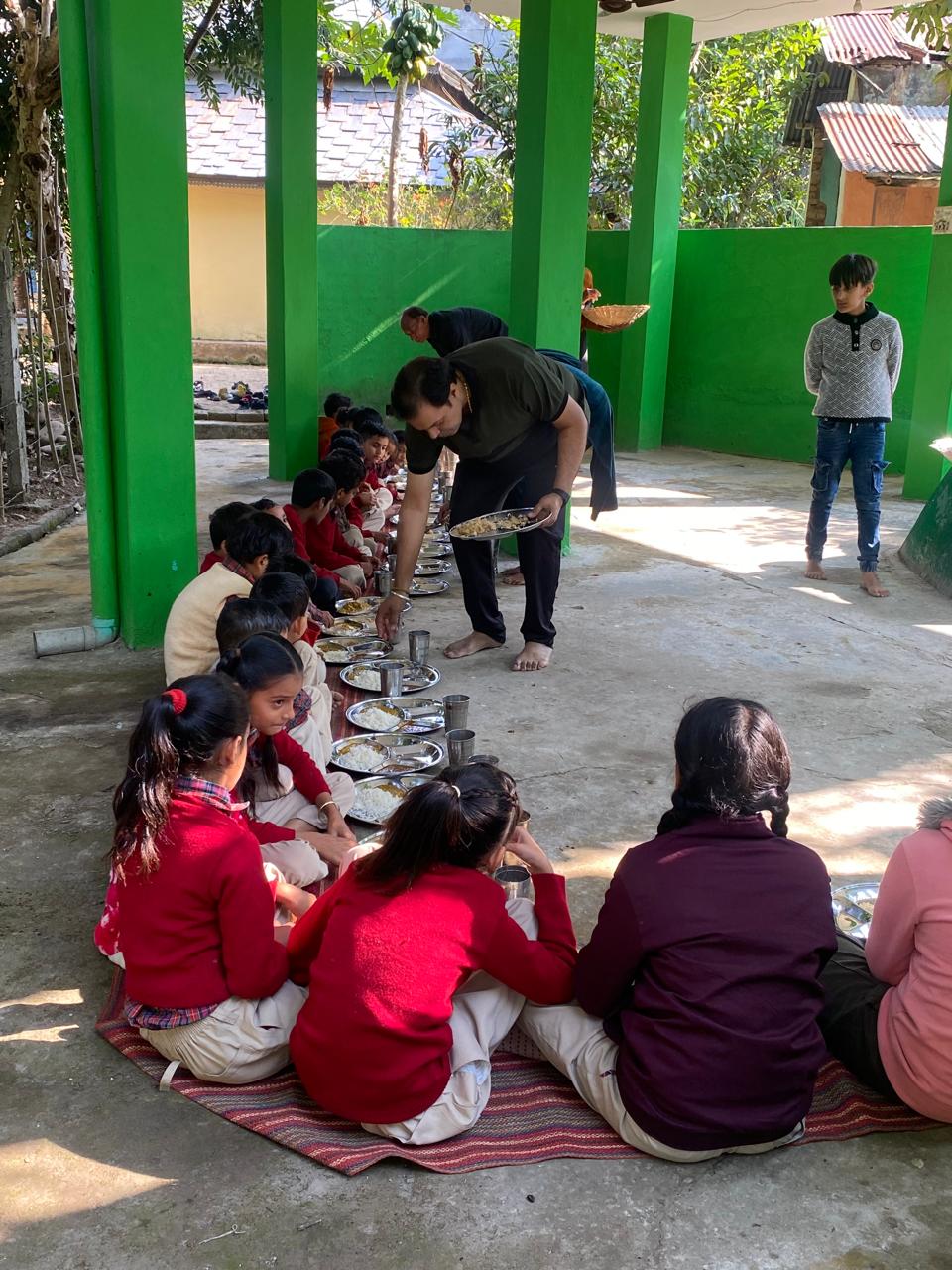 Children enjoying a meal in the trust's courtyard langar
