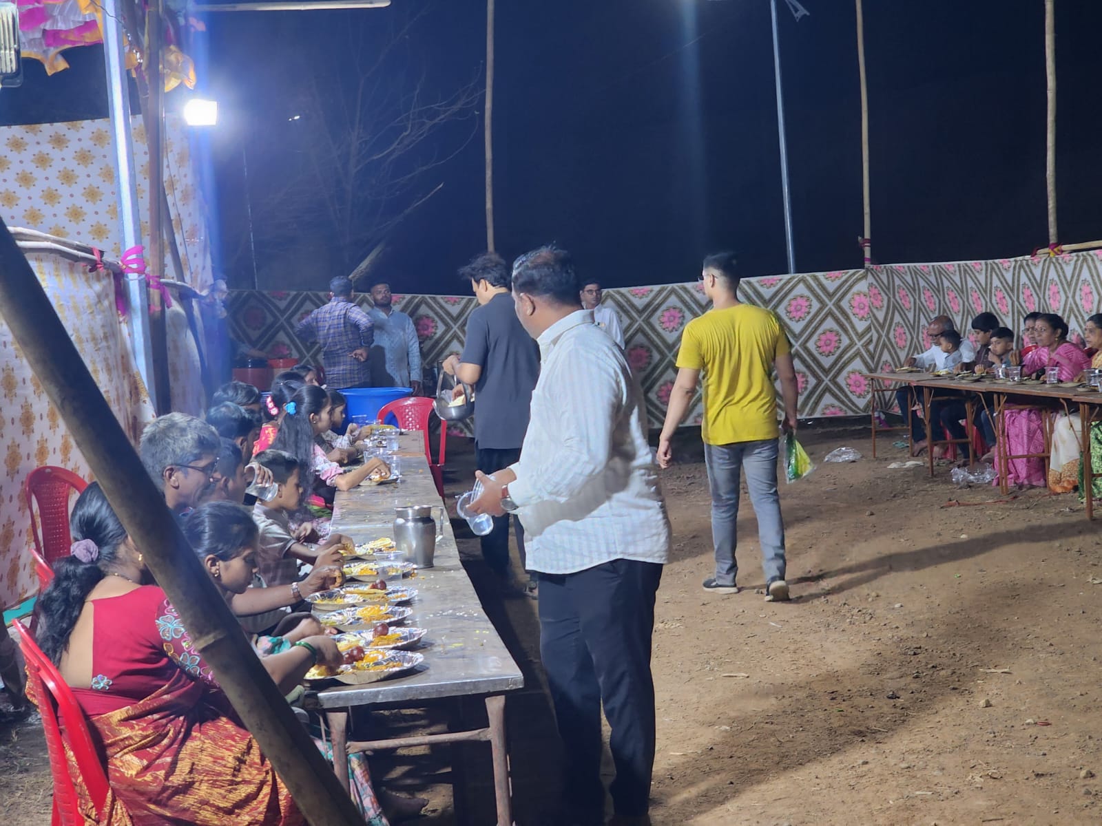 Families dining together at the night langar